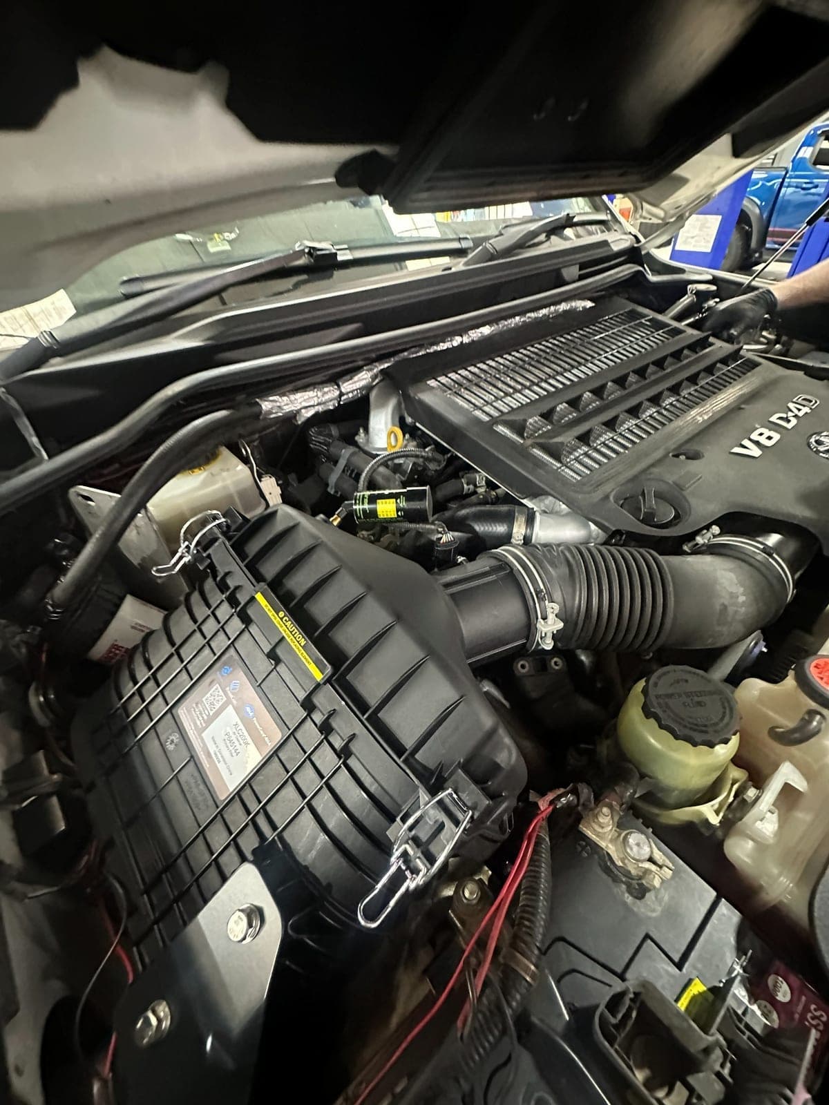 Mechanic working on a 4WD engine bay